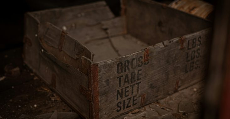 brown wooden crate on brown sand