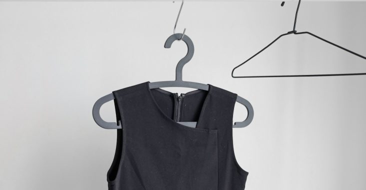 black sleeveless top hanging on wardrobe